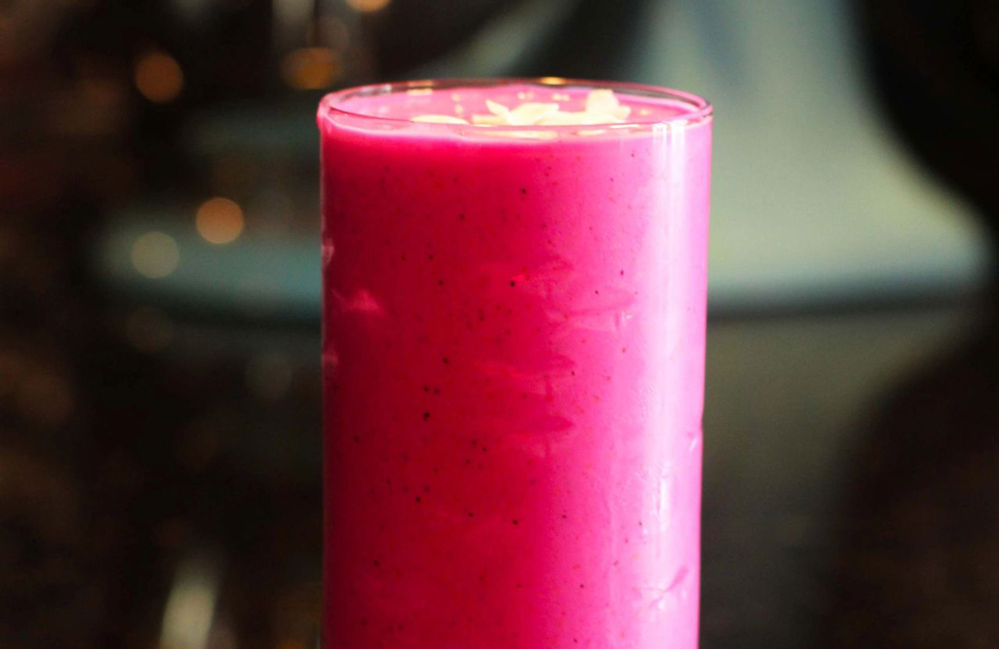 bright pink dragon fruit smoothie in a glass