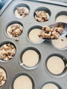 mini muffins being prepared in a muffin tin 