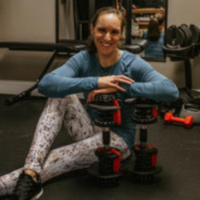 personal trainer and therapist posing with dumbbells 