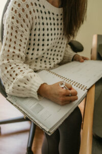 Women writing in her food journal 